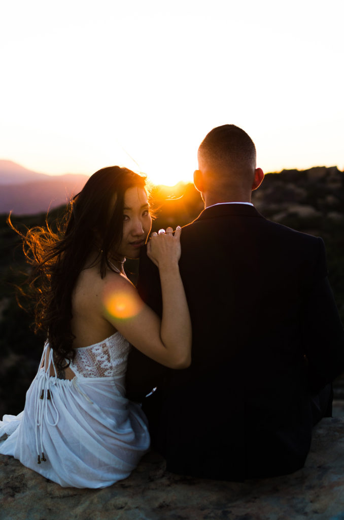 Couple taking Engagement Photos in the mountains during golden hour