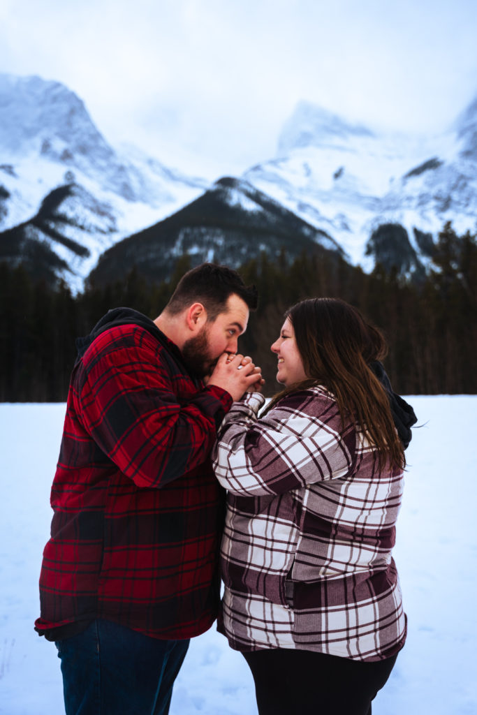 couple holding hands to keep warm in snowy Canada