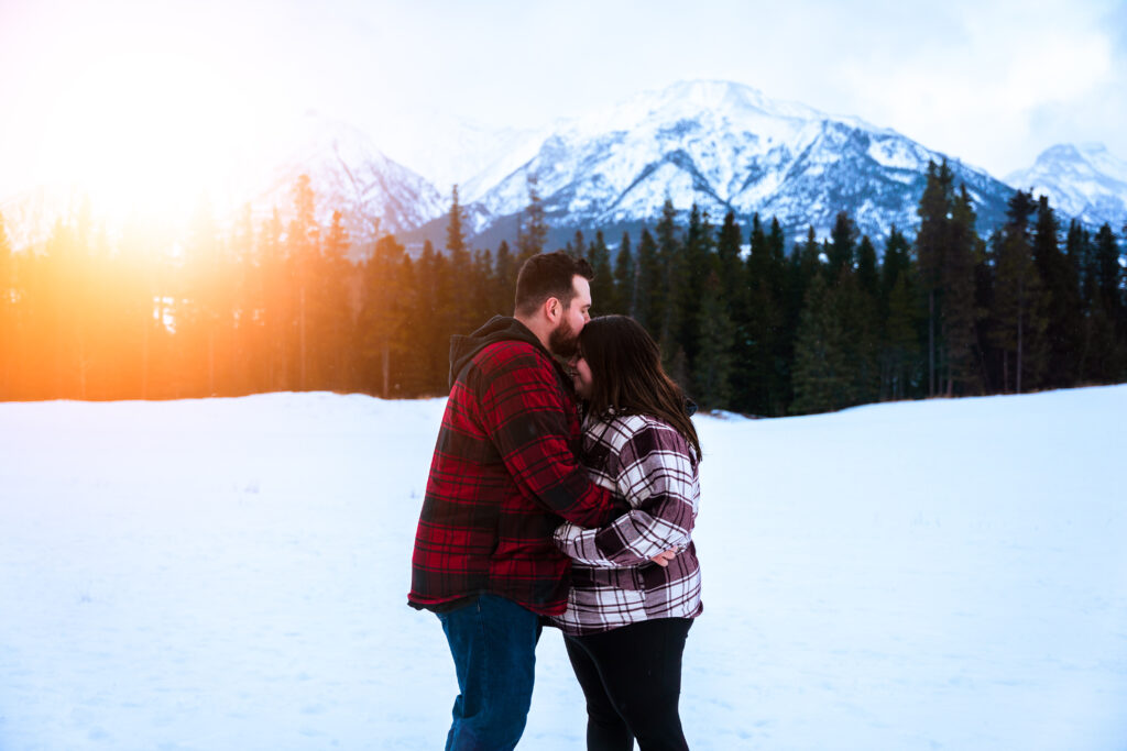 couple engagement photos in Canmore, Alberta with snowy mountains